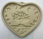 The Pampered Chef Table + Welcome Home Heart Stoneware Baking Mold. Fixed Price $16.95.