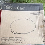 The Pampered Chef 15" Large Round Baking Stone W/ Handles, Brown Uncoated. Fixed Price $49.99.