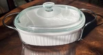 Corningware French White 2.5 Qt Oval Casserole Dish Lid & Metal Cradle. Fixed Price $35.99.