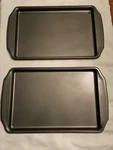 (2) Wilton 10-1/4 In. X 15-1/4 Cookie Sheets Silver Never Used. Fixed Price $21.00.