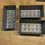 Ovenex Silver Metal Rectangle Loaf Pan Three-piece Set With Patterned Design. Fixed Price $30.00.