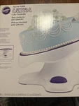 Wilton Tilt-n-turn Ultra Cake Turntable Stand 12", White, Purple New. Fixed Price $74.95.