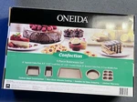 Oneida Confection 5 Pc Bakeware Set Muffin, 2 Cake, Loaf Pan, Cookie Sheet Nib. Fixed Price $20.00.