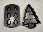 2 Wilton Christmas Pans Tree Cake Gingerbread Men And 6 Cavity. Fixed Price $15.99.