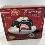 Betty Crocker Bake Fill Cake Pan Set With Dome 4 Piece Open Box. Fixed Price $49.00.