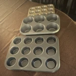 Ecolution Muffin Pan Set Non-stick Silver Gray 6 & 12 Cup Four-piece Metal. Fixed Price $25.00.