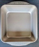 The Pioneer Woman 8-INCH Square Cake Pan Timeless Nonstick Embossed Handles. Fixed Price $15.20.